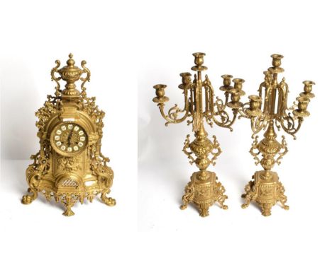 A modern gilt-metal striking mantle clock and a six light candelabra garniture (3)