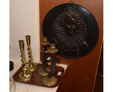 A pair of steel and brass candlesticks modelled as sword hilts; a pair of brass open barley twist candlesticks; a bronzed bra