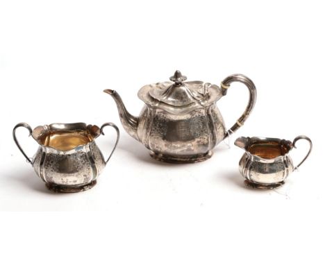 A three piece silver tea service, by Elkington &amp; Co, Sheffield, 1904, each piece fluted and engraved with foliage, the te