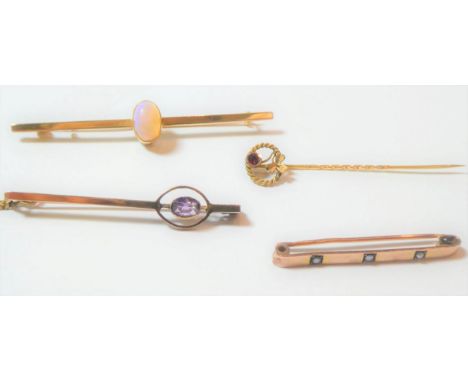 An opal bar brooch, stamped '15CT', length 6.4cm; an amethyst bar brooch, stamped '9CT', length 4.9cm; a 9 carat gold split p