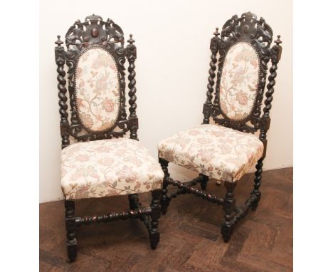 Pair of Victorian carved, dark oak hall or dining room chairs with tapestry upholstered seats and back panels, standing on ba