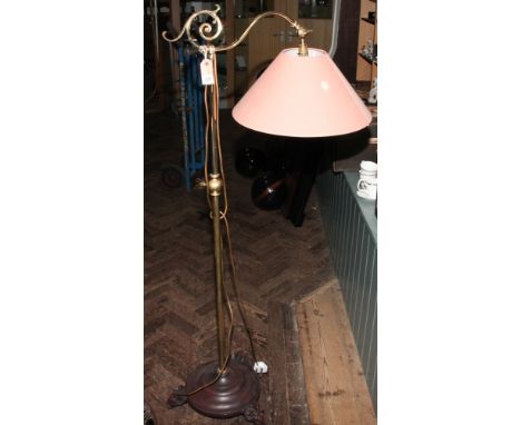 Brass adjustable gallows style standard lamp on rams head foot base together with a pink shade