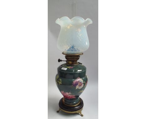 Victorian green and floral decorated oil lamp with vaseline style glass shade, approx 21" high 