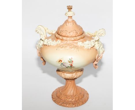 Porcelain blush ivory, twin handled urn and cover, painted with floral sprays with lion mask handles. Marked R W in blue to t