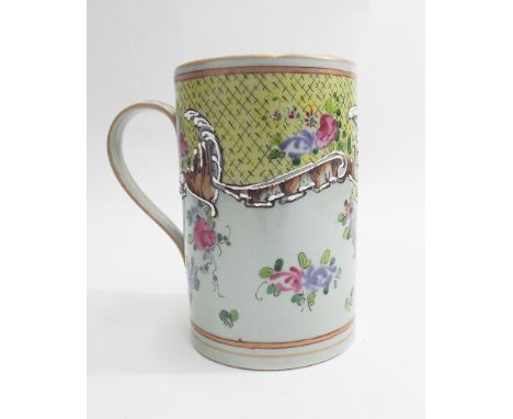 Chinese tankard decorated in the Famille Rose pallet with white tube lined detail - 14 cm tall  Minor chips to white enamel, 