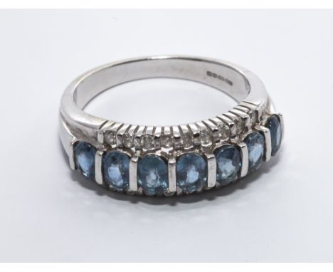 Modern 9ct white gold Ceylon sapphire and diamond half hoop ring - size N