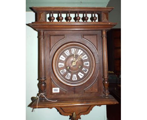 French striking wall clock in a walnut case