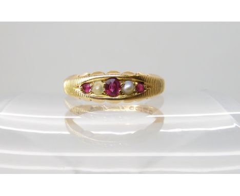 An 18ct gold ruby and pearl ring, dated 1895, size M1/2, weight 2.8gms Condition Report: Available upon request