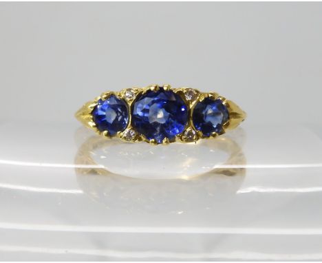 An 18ct gold sapphire and diamond ring with scrolled mount, finger size P, weight 4gms Condition Report: Sapphires a pretty l