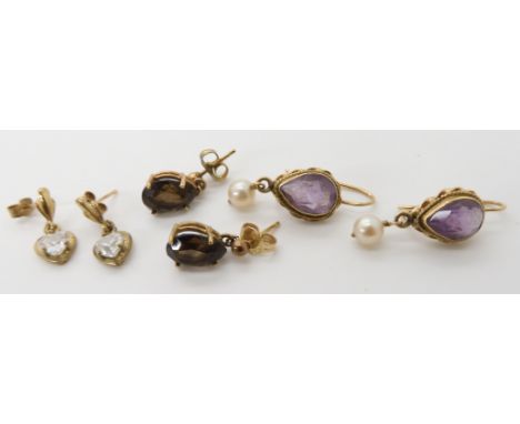 A pair of 14k gold amethyst and pearl earrings, weight 3.4gms and two pairs of 9ct and yellow metal earrings, combined weight