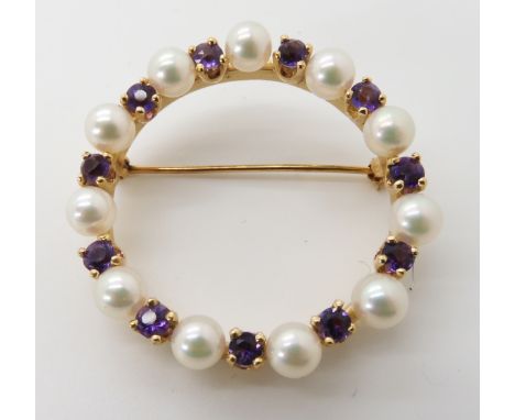 A bright yellow metal circle brooch set with amethyst and pearls, engraved verso 14k, diameter 3.7cm, weight 10gms Condition 