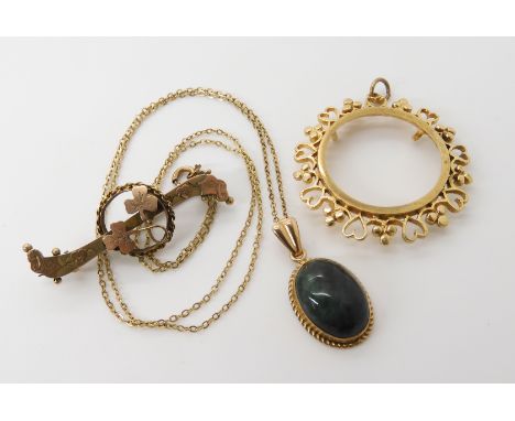 A 9ct gold full sovereign pendant mount, a 9ct shamrock brooch and a 9ct gold green hardstone pendant and chain, weight combi