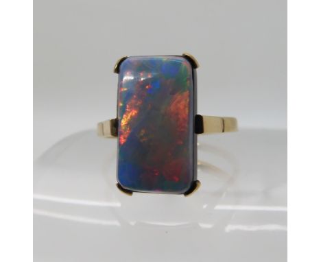 A 9ct gold opal doublet ring, dimension of the opal 17mm x 9mm, finger size S1/2, weight 4gms Condition Report: Opal very col