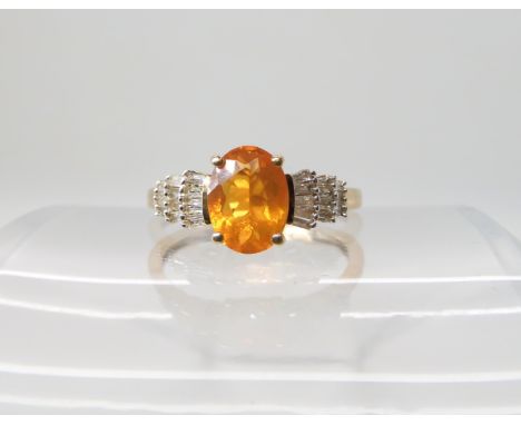 A 9ct gold fire opal and diamond ring, size M1/2, weight 2.2gms Condition Report:Diamonds appear clean and bright by eye, wit