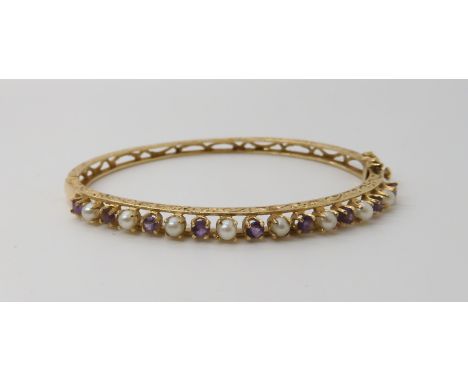 A 14k gold amethyst and pearl bangle, weight 10.1gms Condition Report: Available upon request