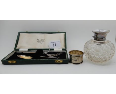 A lot comprising a cased two piece silver christening set, Sheffield 1938, a silver topped scent bottle and a napkin ring (3)