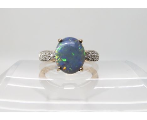 A 9ct opal and diamond ring size O, weight 3.2gms Condition Report: the matrix is grey, with the opal bit uneven to both side