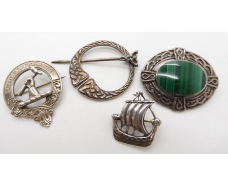 A collection of silver brooches to include a Ward Brothers Viking boat brooch, a silver clan badge etc Condition Report: ligh