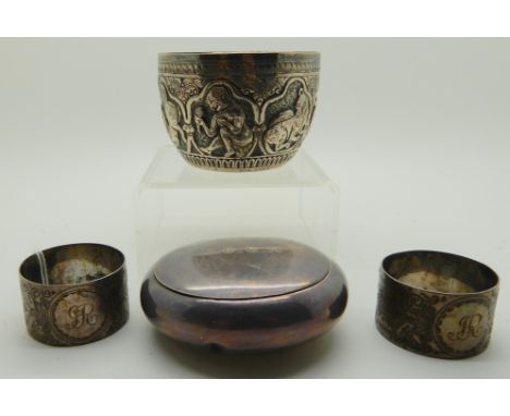A lot comprising a Burmese white metal bowl, two napkin rings and a circular snuff box Condition Report: Available upon reque