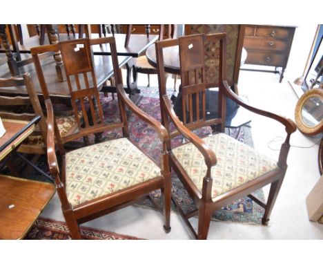 A pair of Edwardian mahogany carver chairs having drop in tapestry seats