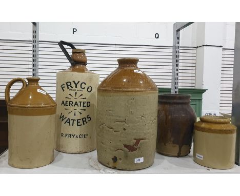 Stoneware flagons including one labelled "Fryco Trademark Aerated Waters R. Fry and Co Limited" 49cms high,with carry handle 