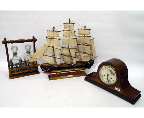 Mahogany mantel clock in Napoleon's hat shaped case, with chiming movement, two bottle tantalus and model sailing ship "Friga
