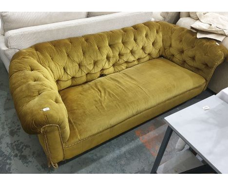 A Victorian button-back Chesterfield sofa in olive green upholstery, on turned supports to castors 