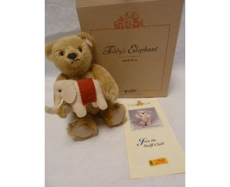 A Steiff collectors teddy bear named Teddy's Elephant&nbsp;, a teddy with a felt elephant stitched to his paws in original bo