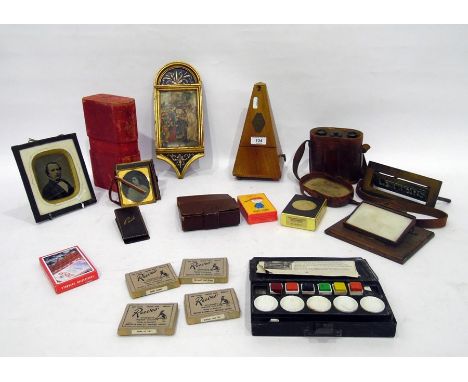 Maelzel metronome, pair of binoculars in leather carrying case, Ambro-type portrait photograph, other old photos, card game, 