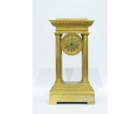 Regency gilt brass four pillar clock having dentil and egg and dart pediment, the gilt movement with bead and foliate borders