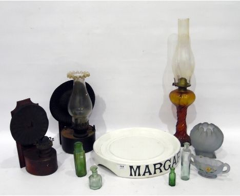 Two old metal backed oil lanterns, amber glass oil lamp, large shop display "Margarine" holder, aqua glass bottle and other i
