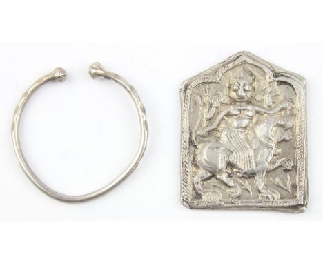 A silver pendant or amulet depicting the goddess Durga riding a lion, hand embossed, Mughal Empire 16th-19th century, XRF ass