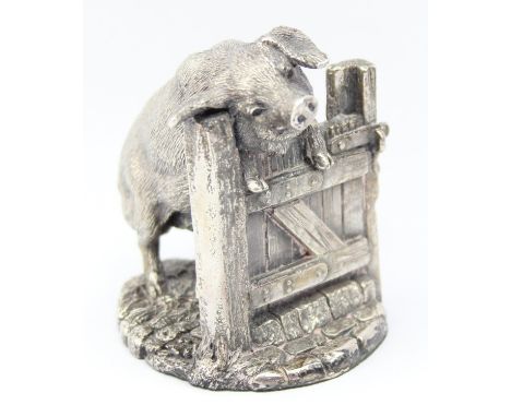 A Country Artists silver filled model of a pig on a wooden gate, marked for Birmingham 1997, 8cm tall
