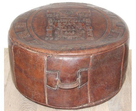 A retro thick leather footstool or pouffe with Aztec or Incan style design, 53cm in diameter x 29cm tall