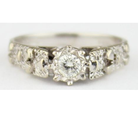 [3.36g, K] - A retro 18ct white gold and solitaire diamond ring, the diamond assessed as 0.25ct and in bark effect retro sett
