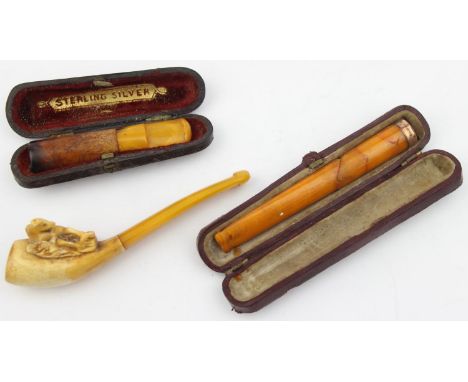 A 9ct gold mounted amber cheroot or cigar holder a/f, a carved meerschaum pipe with horse and a further boxed cheroot holder 
