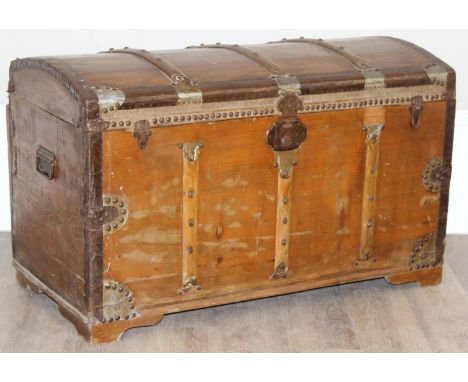 An antique stained pine dome-topped chest or trunk with metal banding, approx 95cm x 49cm x 56cm