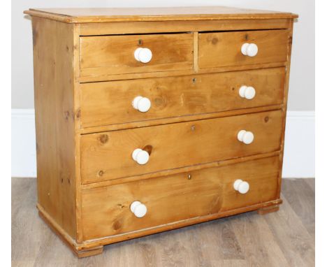 An antique 2 over 3 pine chest of drawers with white ceramic handles, 99cm x 51cm x 88cm
