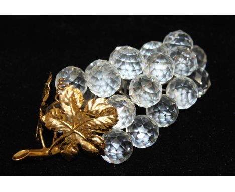 Swarovski crystal bunch of grapes featuring 23 clear crystal grapes on a rhodium stem with gold-coloured leaves, part of the 