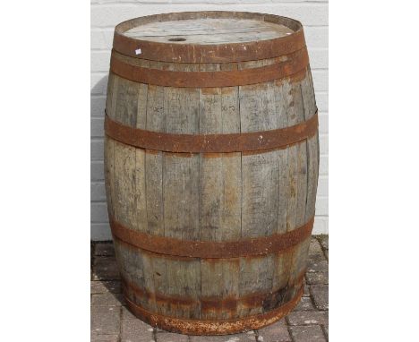 A large vintage oak whisky barrel with iron hoops, 97cm tall