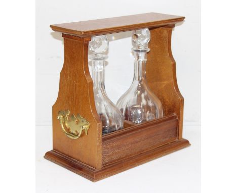 A modern two bottle tantalus with two cut glass and bombe shaped decanters, key present but lock not opening, 36cm wide