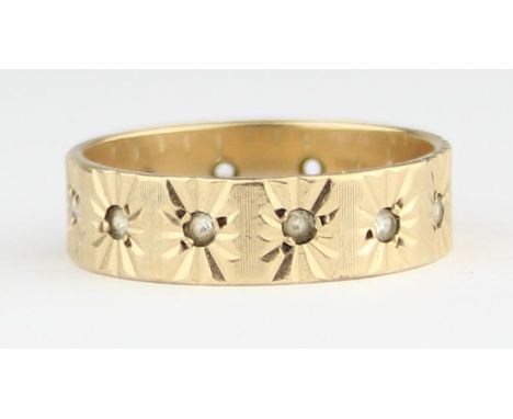 [3.24g, R] - a retro 9ct gold and white stone eternity ring, Birmingham 1972, star cut settings, one stone missing, presented