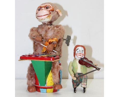 2 vintage mechanical and tin plate toys to inc a monkey playing a glockenspiel, marked Made in Japan, 22cm &amp; a Schuco clo