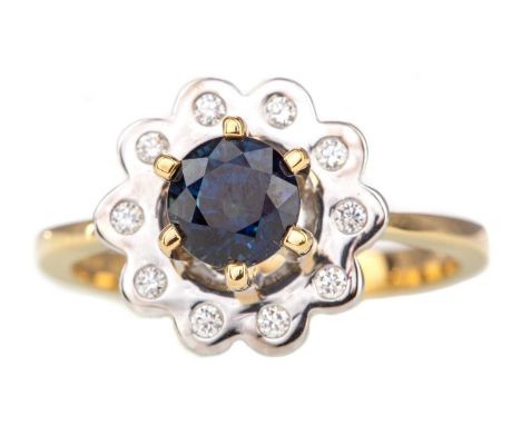 SAPPHIRE AND DIAMOND RING,the high set sapphire to a bezel set halo of diamonds, in eighteen carat gold, size R, 7.6g