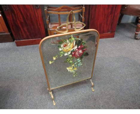 A mirrored brass fireguard with rose motif, painted on glass 