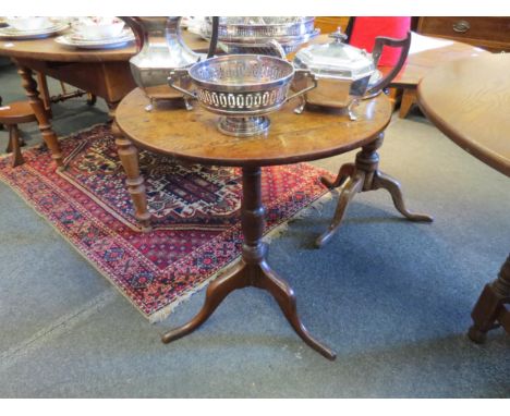 A 19th Century oak tripod table with vase shape column. 70cm high x 57cm diameter 