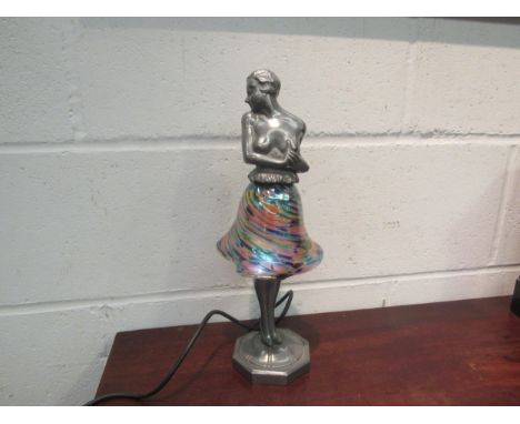 A 1920's style Brevette cast alloy lamp of a semi-clad lady with iridescent shade as a skirt, 36cm height 