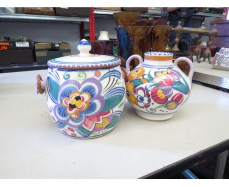 A traditional Poole Pottery biscuit barrel by Rene Hayes and a Hilda Hampton twin handled vase. Tallest 15.5cm  (2) 