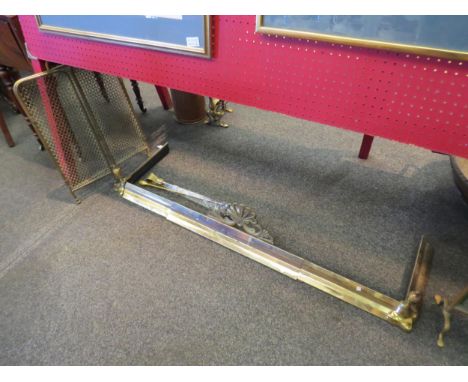 A brass fire fender, two tools and a fire guard 