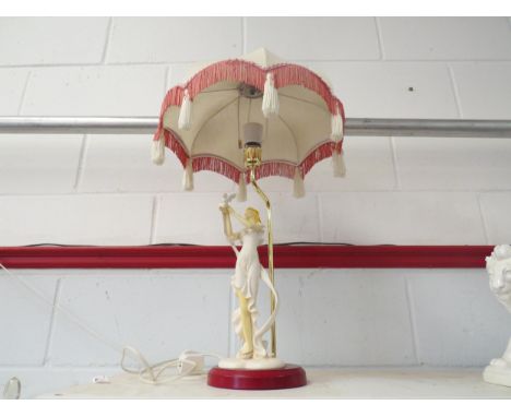 A modern table lamp, young woman with dove, frilled and tassled shade 